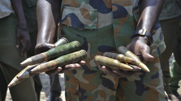 In this photo taken Saturday, Aug. 19, 2017, South Sudanese army commander Col. James Gatjiath holds ammunition captured from opposition fighters during recent clashes in Kuek, northern Upper Nile state, South Sudan. - Sputnik Africa
