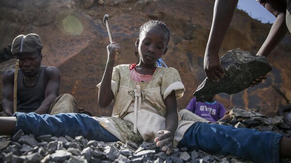 Irene Wanzila, 10, works breaking rocks with a hammer along with her younger brother, older sister and mother, who says she was left without a choice after she lost her cleaning job at a private school when coronavirus pandemic restrictions were imposed, at Kayole quarry in Nairobi, Kenya Tuesday, Sept. 29, 2020. - Sputnik Africa