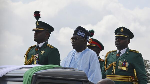 Nigeria's President Bola Ahmed Tinubu inspects an honour guard during the Democracy day celebration in Abuja, Nigeria, Wednesday, June 12, 2024.  - Sputnik Africa