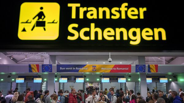 Passengers arriving at the Henri Coanda International Airport pass under a Schengen Information sign, in Otopeni, near Bucharest, Romania, Sunday, March 31, 2024. - Sputnik Africa