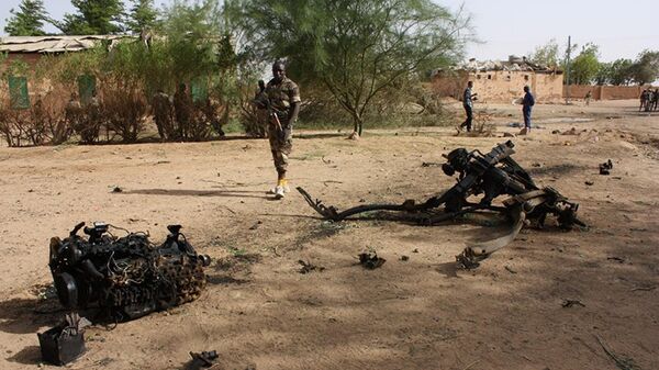 Nigerien soldiers walk near debris after suicide bombers blew themselves up inside a military barracks, in Agadez, northern Niger - Sputnik Africa