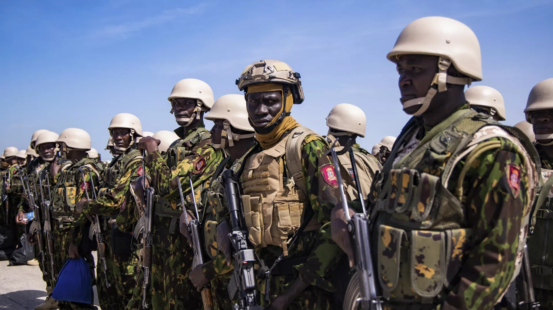 Police from Kenya stand on the tarmac of the Toussaint Louverture International Airport after landing in Port-au-Prince, Haiti, Tuesday, June 25, 2024