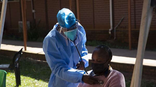 A woman is screened for COVID-19 at a testing centre in Soweto, South Africa - Sputnik Africa