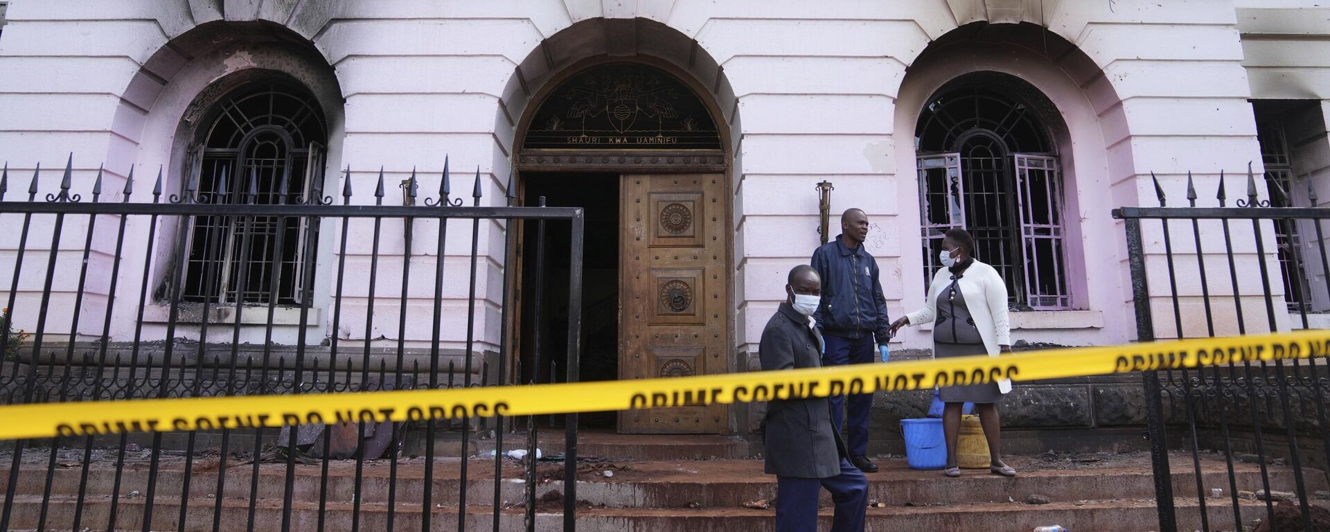 Nairobi county workers stand in front of the governor's office, which was burned during yesterday's protest over proposed tax hikes in a finance bill in downtown Nairobi, Kenya Wednesday, June 26, 2024. - Sputnik Africa, 1920, 28.06.2024