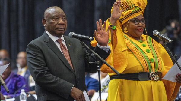 South African président Cyril Ramaphosa raises his hand as he is sworn is as a member of Parliament ahead of an expected vote by lawmakers to decide if he is reelected as leader of the country in Cape Town, South Africa, Friday, June 14, 2024. - Sputnik Africa