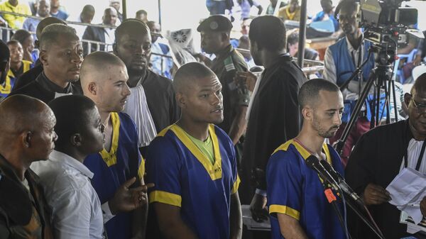 Tyler Thompson Jr, Marcel Malanga and Benjamin Reuben Zalman-Polun, all American citizens, face the court in Kinshasa with 52 other defendants  - Sputnik Africa