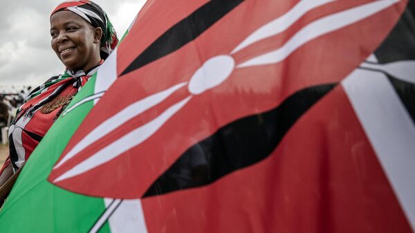 Veronica Wandiki holds a Kenyan flag during the celebrations of Kenya's 60th Independence Day, also known as Jamhuri Day, at the Uhuru Gardens in Nairobi on December 12, 2023.  - Sputnik Africa