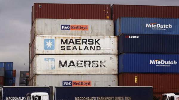 Goods are stacked in containers destined for global distribution near the harbor in Cape Town, South Africa - Sputnik Africa
