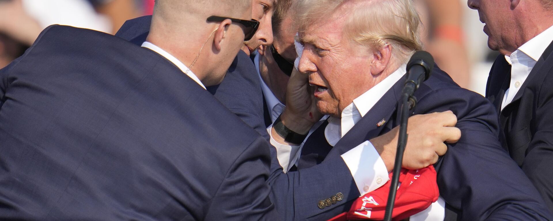 Republican presidential candidate former President Donald Trump is helped off the stage by US Secret Service agents at a campaign event in Butler, Pa., on Saturday, July 13, 2024. - Sputnik Africa, 1920, 14.07.2024