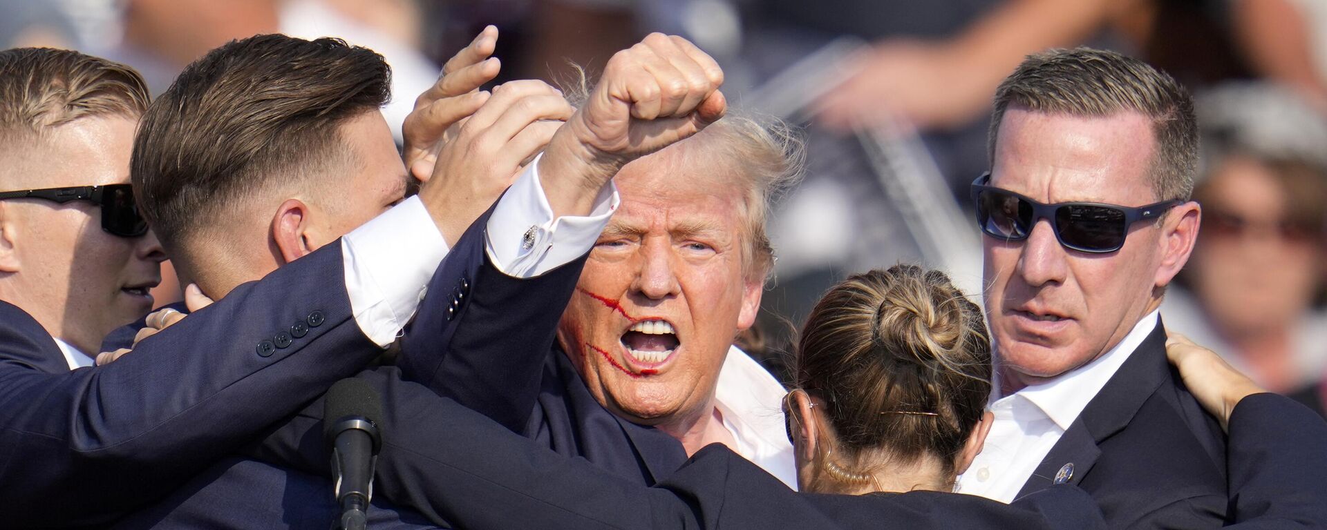 Republican presidential candidate former President Donald Trump is helped off the stage by U.S. Secret Service agents at a campaign event in Butler, Pa., on Saturday, July 13, 2024.  - Sputnik Africa, 1920, 14.07.2024