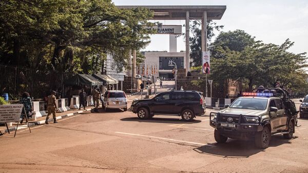 An Uganda police patrol car drives past the entrance to the Parliament ahead of a planned anti-corruption demonstration in Kampala on July 23, 2024.  - Sputnik Africa