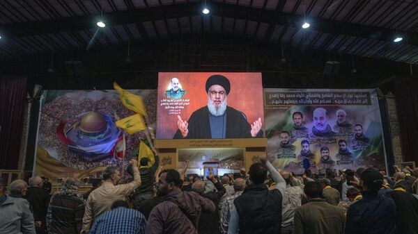 Hezbollah leader Sayyed Hassan Nasrallah speaks in a televised address via a video link during a ceremony to commemorate the death of the Iranian Revolutionary Guard Gen. Mohammad Reza Zahedi, and six officers, who were killed by an Israeli airstrike - Sputnik Africa