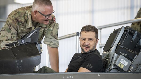 Volodymyr Zelensky sits in a F-16 fighter jet in the hangar of the Skrydstrup Airbase in Vojens, northern Denmark, - Sputnik Africa