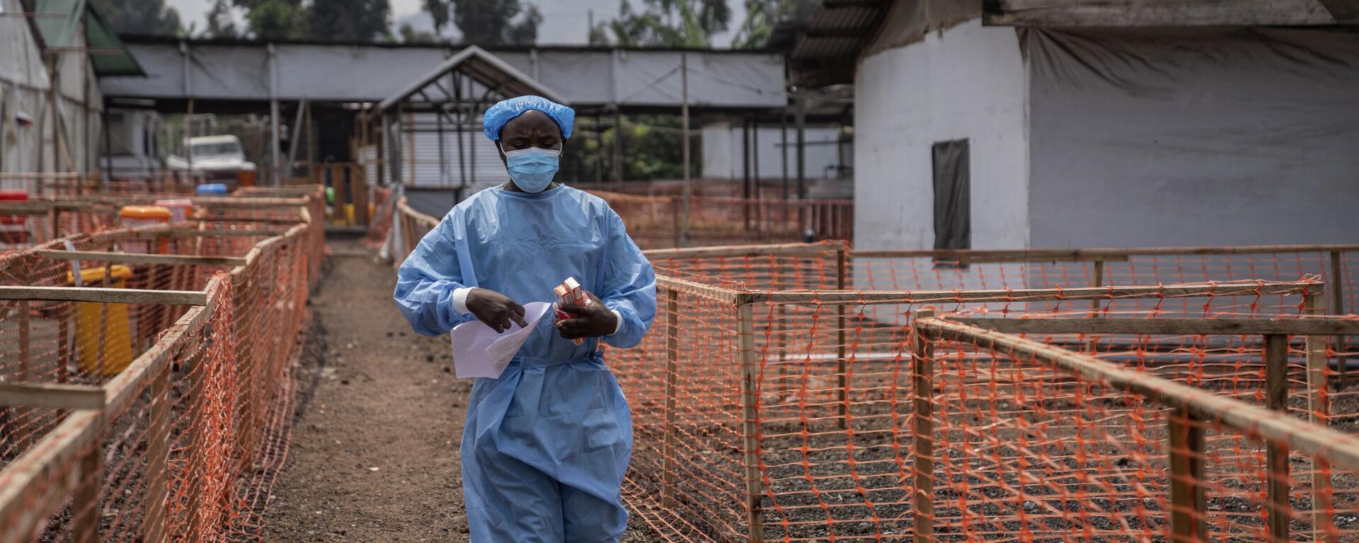 A health worker walks past a mpox treatment centre in Munigi, eastern Congo, Friday, Aug. 16, 2024.  - Sputnik Africa, 1920, 22.08.2024