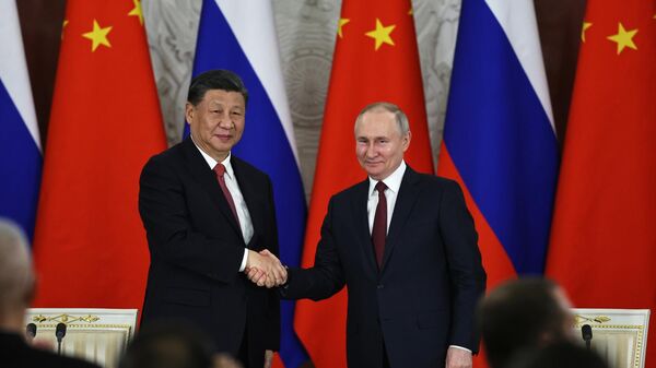 Russian President Vladimir Putin, right, and Chinese President Xi Jinping shake hands after speaking to the media during a signing ceremony following their talks at The Grand Kremlin Palace, in Moscow, Russia, March 21, 2023 - Sputnik Africa