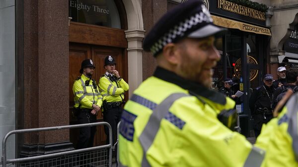 Police officers patrol outside the London offices of the political party Reform UK, ahead of an anti-far right protest - Sputnik Africa