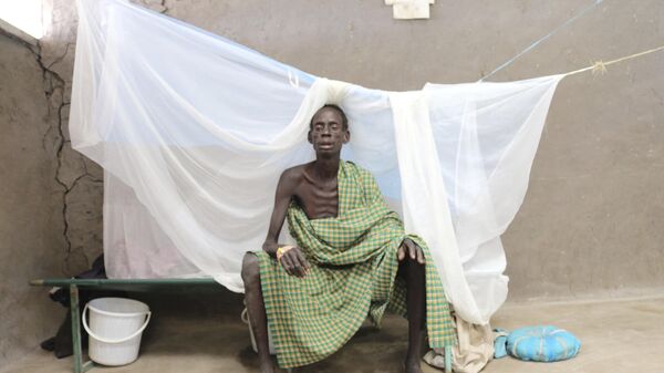 Machar Weituor sits on his bed  at a cholera clinic in Pieri South Sudan - Sputnik Africa