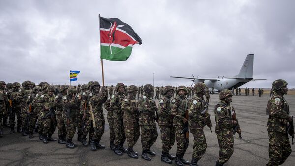 Members of the Kenya Defence Forces (KDF), one holding a national flag, line up to board transport aircraft as they deploy to Goma in eastern Congo as part of the East African Community Regional Force (EACRF), at a military airport in Nairobi, Kenya Wednesday, Nov. 16, 2022.  - Sputnik Africa