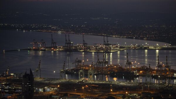 Gantry cranes used to load and unload cargo containers from ships sit stand during the dawn, in the port of Haifa, Israel - Sputnik Africa