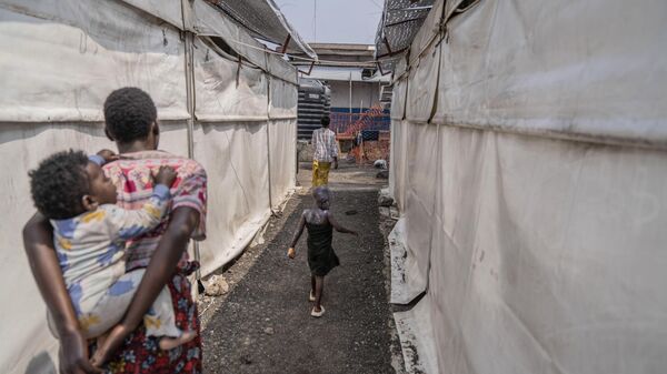 A girl suffering from mpox walks past a treatment centre in Munigi, eastern Congo, - Sputnik Africa