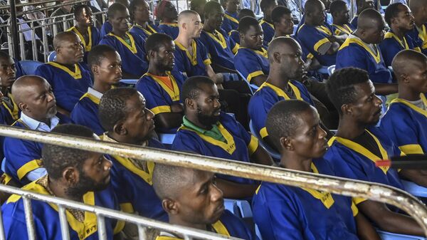 American Tyler Thompson Jr, center top left, sits in court in Kinshasa with 52 other defendants, Friday, June 7, 2024. - Sputnik Africa