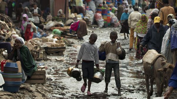 Shoppers and vendors make their way down a flooded street in Merkato, one of Africa's largest market areas, in Addis Ababa, Ethiopia  - Sputnik Africa