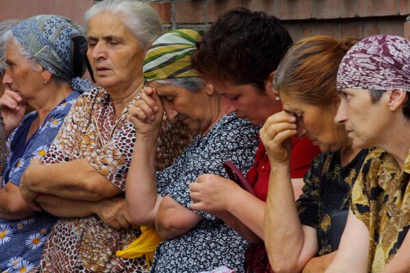 Ossetian women sit waiting for news not far from the school seized by attackers in Beslan, North Ossetia, Wednesday, Sept. 1, 2004. Attackers wearing suicide-bomb belts seized the Russian school in a region bordering Chechnya on Wednesday, taking hostage about 400 people, half of them reportedly children, and threatening to blow up the building. - Sputnik Africa