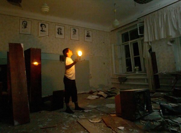 A boy, who wasn&#x27;t a hostage, looks around a literature classroom in the school seized by terrorists, in Beslan, North Ossetia, Saturday, Sept. 4, 2004.   - Sputnik Africa