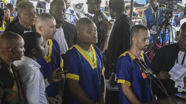 From left, Tyler Thompson Jr., Marcel Malanga and Benjamin Reuben Zalman-Polun, all American citizens, face the court in Kinshasa, Congo, with 52 other defendants, June 7, 2024, accused of a role in the attempted coup in Congo led by little-known opposition figure Christian Malanga in which six people were killed. - Sputnik Africa