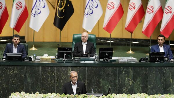 Iran's President-elect Masoud Pezeshkian (center, foreground) at his inauguration ceremony in Tehran. Center, background: Chairman of the Islamic Consultative Assembly of the Islamic Republic of Iran Mohammad Bagher Ghalibaf. - Sputnik Africa