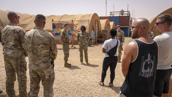 In this image by the U.S. Air Force, Maj. Gen. Kenneth P. Ekman speaks to military members in front of a Welcome to Niamey sign depicting U.S. military vehicles at Air Base 101 in Niger, May 30, 2024. - Sputnik Africa