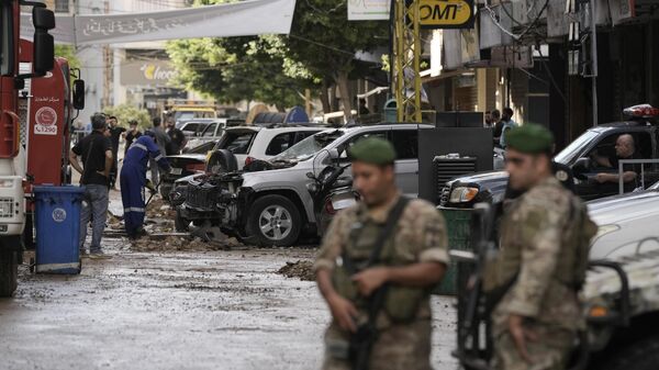 Lebanese soldiers stand guard near the site of Friday's Israeli strike in Beirut's southern suburb, Sunday, Sept. 22, 2024. - Sputnik Africa