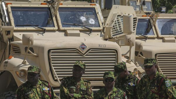 Kenyan police officers, part of a UN-backed multinational force, stand next to armored vehicles on their base during a visit by Kenya's President William Ruto, in Port-au-Prince, Haiti, Saturday, Sept. 21, 2024. - Sputnik Africa