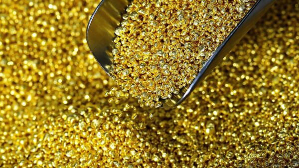 An employee fills a container with granulated gold of the highest standard 99.99 at the Krasnoyarsk Non-Ferrous Metals Plant named after V.N. Gulidov. - Sputnik Africa