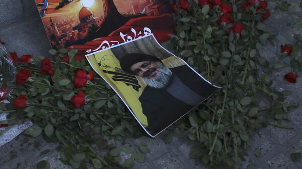 A poster of Hezbollah leader Sayyed Hassan Nasrallah is placed on flowers in front of the Lebanese Embassy in Tehran, Iran, Wednesday, Sept. 18, 2024. - Sputnik Africa