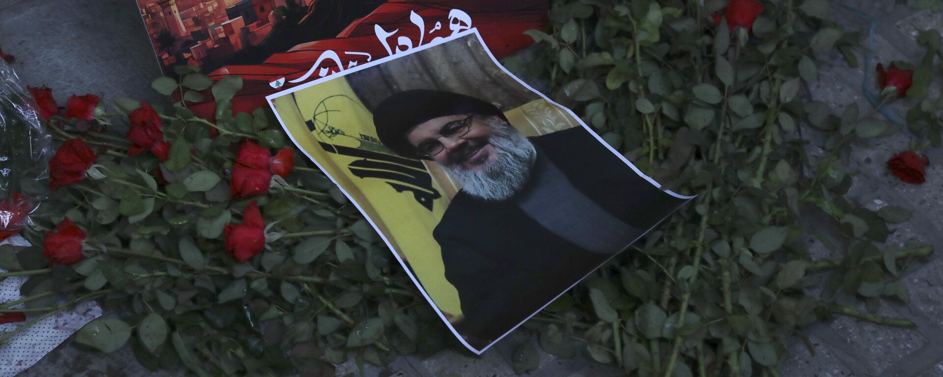 A poster of Hezbollah leader Sayyed Hassan Nasrallah is placed on flowers in front of the Lebanese Embassy in Tehran, Iran, Wednesday, Sept. 18, 2024. - Sputnik Africa, 1920, 28.09.2024