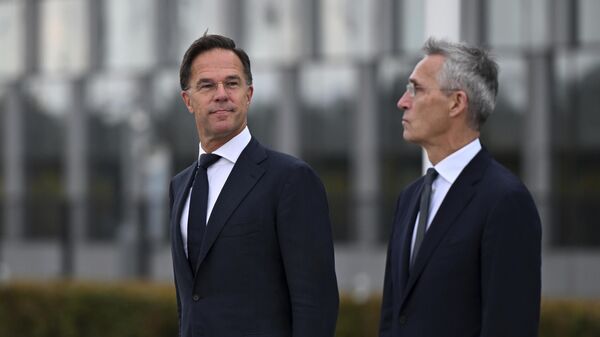 The incoming NATO Secretary General Mark Rutte, left, and NATO Secretary General Jens Stoltenberg stand during a wreath laying ceremony at NATO headquarters in Brussels, Belgium, Tuesday, Oct. 1, 2024. - Sputnik Africa