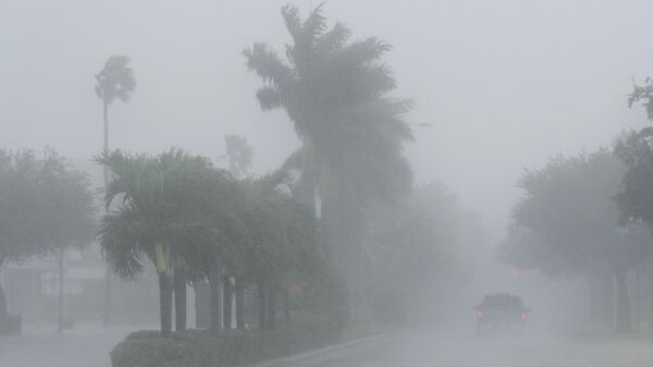 A Lee County Sheriff's officer patrols the streets of Cape Coral, Florida, as heavy rain falls ahead of Hurricane Milton, Wednesday, Oct. 9, 2024. - Sputnik Africa