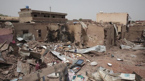 A man walks by a house hit in recent fighting in Khartoum, Sudan, an area torn by fighting between the military and the notorious paramilitary Rapid Support Forces, April 25, 2023.  - Sputnik Africa