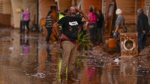 A man reacts in front of houses affected by floods in Utiel, Spain, Wednesday, Oct. 30, 2024.  - Sputnik Africa