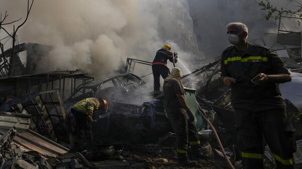 Civil defense workers extinguish a fire as smoke rises from the site of an Israeli airstrike in Dahiyeh, Beirut, Lebanon, Friday, Nov. 1, 2024 - Sputnik Africa