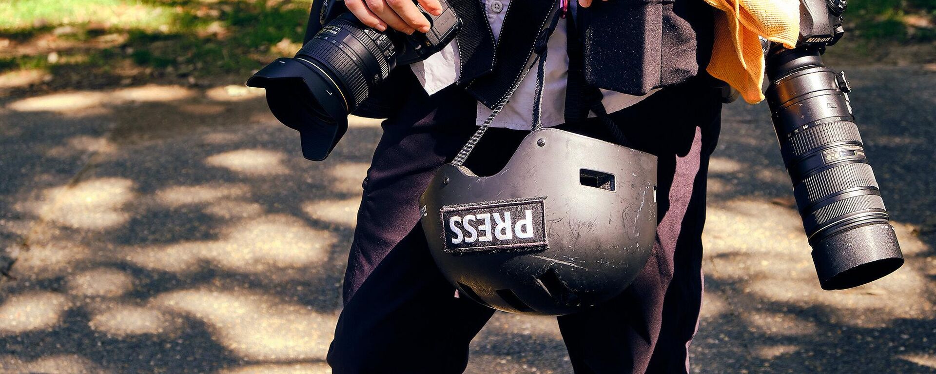 A journalist carrying a press helmet - Sputnik Africa, 1920, 19.11.2024