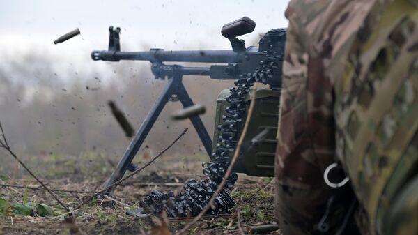 A scout of the 25th combined arms army of the Western group of forces fires a machine gun in the zone of a special military operation. - Sputnik Africa