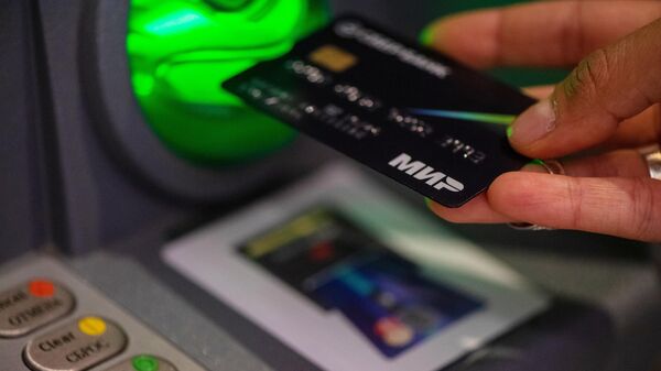 A MIR bank card is seen being used in Yerevan, Armenia. File photo - Sputnik Africa