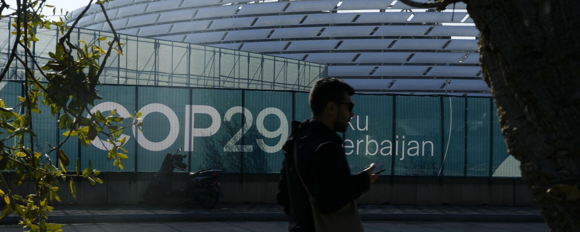 A person walks outside the Baku Olympic Stadium, the venue for the COP29 UN Climate Summit, Sunday, Nov. 10, 2024, in Baku, Azerbaijan. - Sputnik Africa, 1920, 24.11.2024