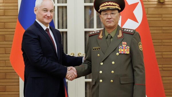 Russian Defence Minister Andrei Belousov and North Korean Defence Minister No Kwang Chol shake hands as they pose for photos before their meeting in Pyongyang, North Korea. - Sputnik Africa