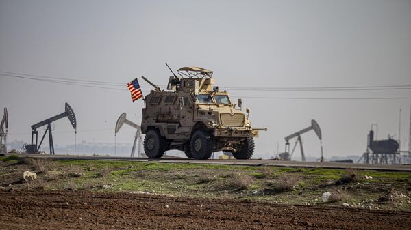 A US military vehicle is seen on a patrol in the countryside near the town of Qamishli, Syria, Sunday, Dec. 4, 2022. - Sputnik Africa