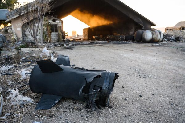 DAMASCUS, SYRIA - DECEMBER 15: After an Israeli strike on Syria , the tail of a Russian-made rocket lies on the ground as smoke rises from shipping casings for rockets, near the tarmac at the Mezzeh Military Airport, after more than 500 Israeli strikes against military targets across Syria since the fall of the Assad regime, on December 15, 2024, in Damascus, Syria. Israel says it is destroying Syria&#x27;s military capabilities to prevent any threat from the Islamist forces of Hayat Tahrir al-Sham (HTS), though the HTS leader over the weekend warned Israel to stop such attacks. The fall of the Assad regime marks a new chapter for Syria, which has been mired in a multi-party civil war since 2011, sparked by the Arab Spring uprisings. (Photo by Scott Peterson/Getty Images) - Sputnik Africa