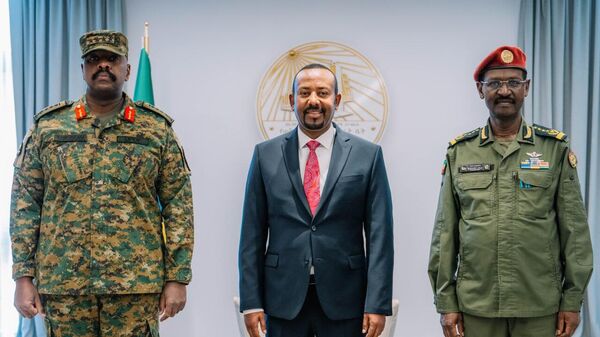 Ethiopian Prime Minister Abiy Ahmed (C), joined by the Chief of Staff of the Ethiopian National Defense Forces (ENDF) Field Marshal Birhanu Jula (R), meets in his office with General Muhoozi Kainerugaba, the head of the Ugandan People's Defense Forces (UPDF), on Monday, December 16, 2024. - Sputnik Africa