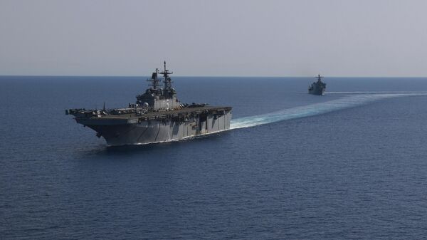 In this photo released by the U.S. Navy, the amphibious assault ship USS Bataan, front, and the landing ship USS Carter Hall, back travel through the Red Sea - Sputnik Africa